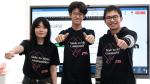 Three students giving a thumbs up.